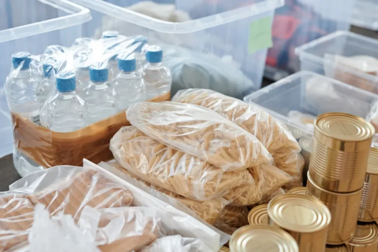 Be Ready campaign urges every Briton to stockpile water and food Plastic-wrapped food items and bottled water organized in storage containers and tin cans