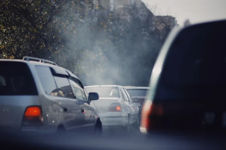 Burnham urged to launch air pollution inquiry over health inequalities City traffic jam with cars emitting smoke on a busy road